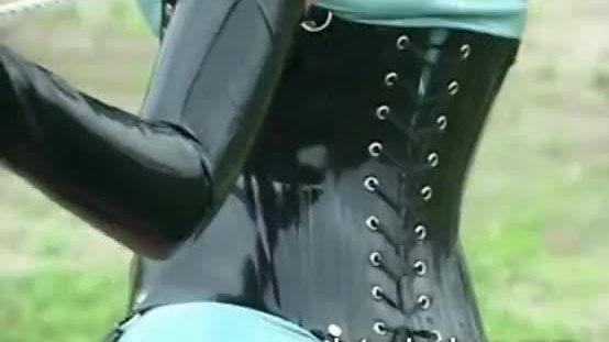 Rubber lesbians outdoors scissoring